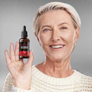 Woman in her fifties holding a bottle of Sugar Defender drops