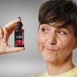 Woman holding a bottle of Sugar Defender drops